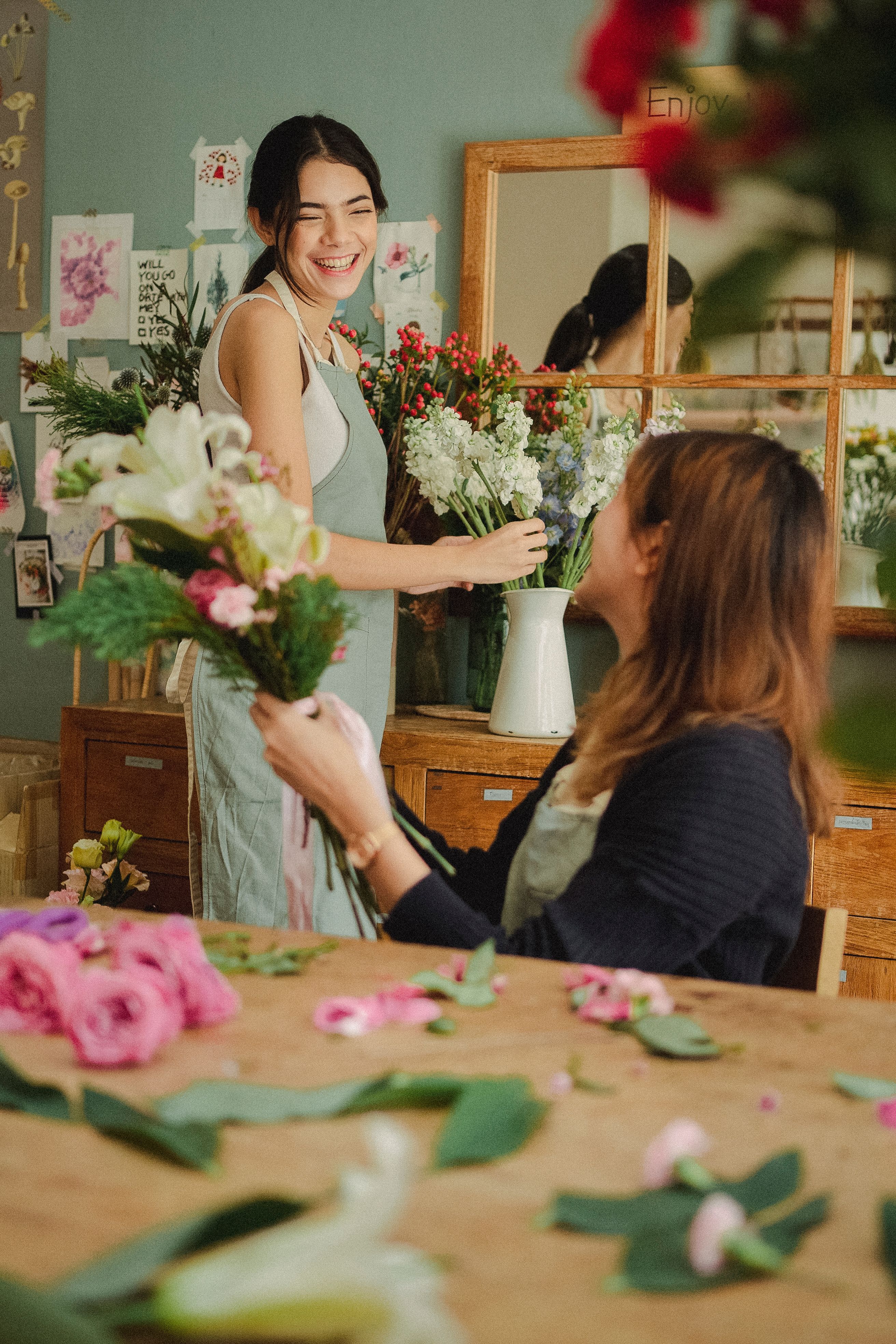 A florist arranging a bouquet with a customer